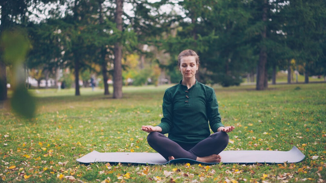 person meditating in nature