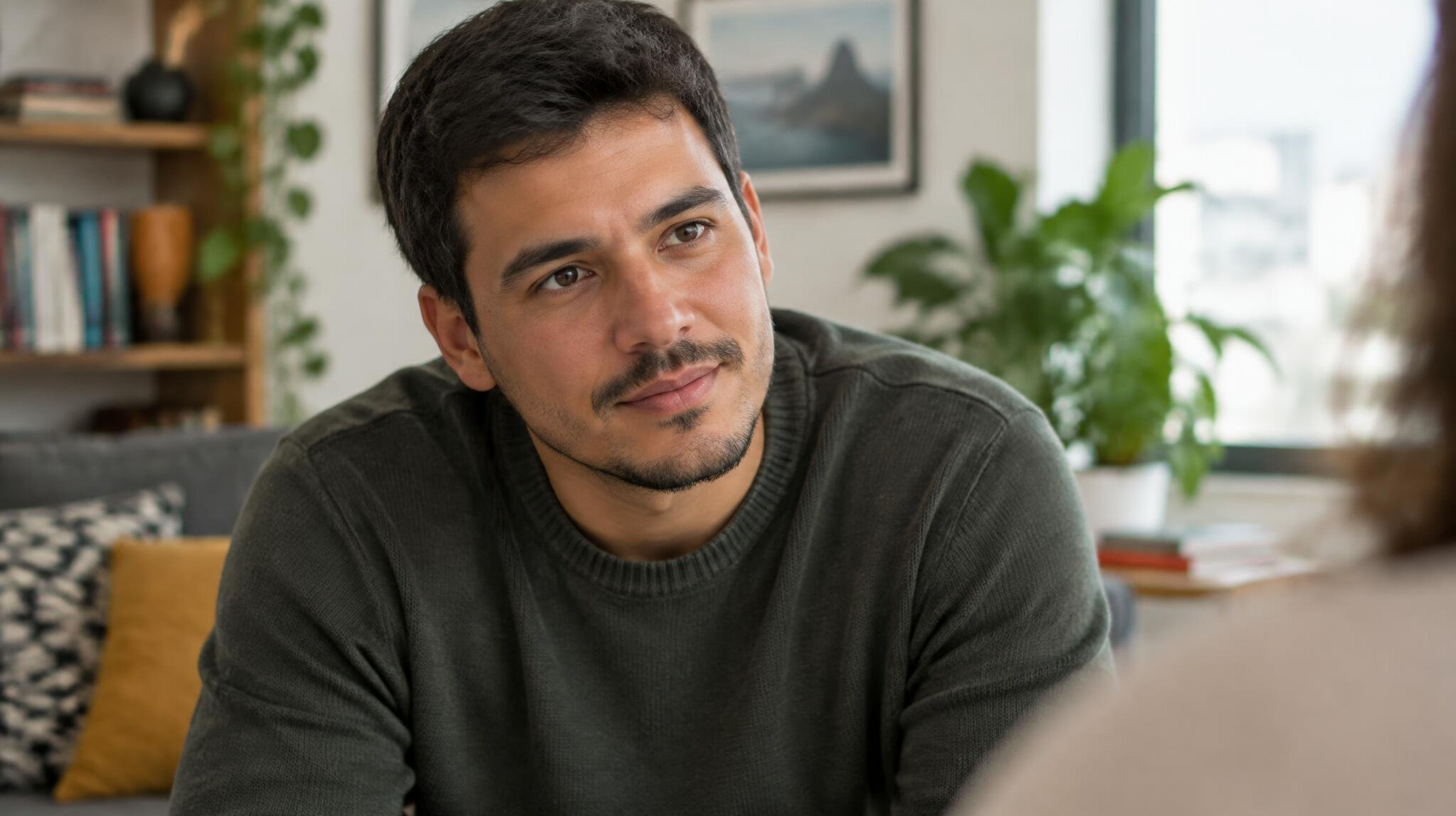 Brazilian man leaning in attentively while practicing active listening during a conversation